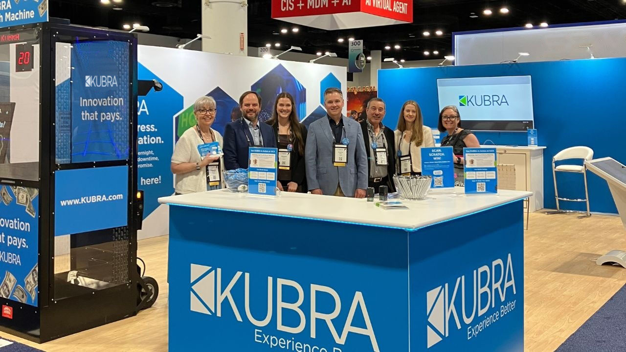 Photo of a group of people standing in a KUBRA trade sh
